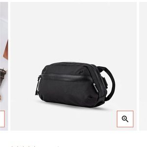 Wandrd pouch with internal organization pockets and carry strap